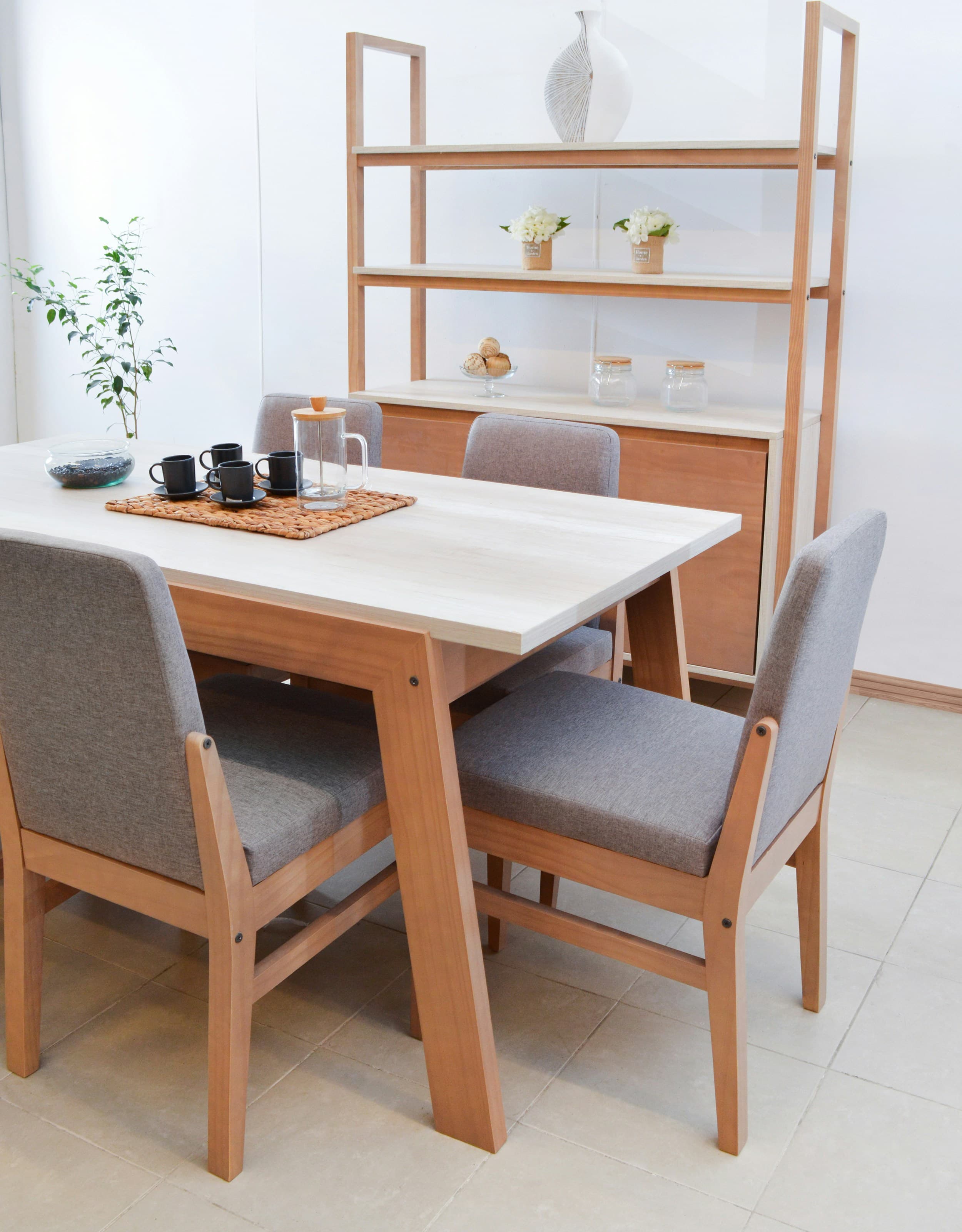 Bright modern dining room with wooden table, grey chairs, and shelving